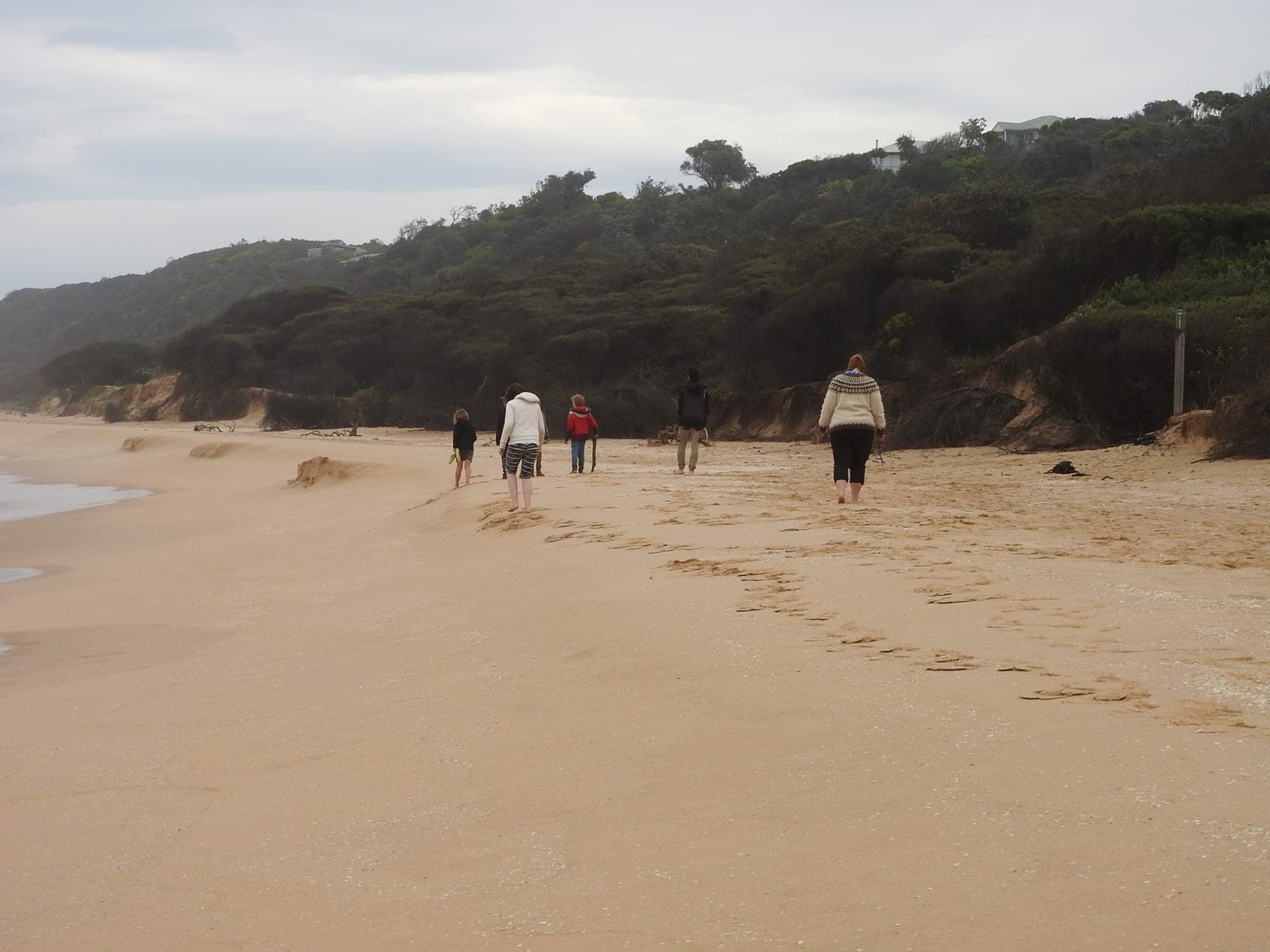 Family walking along an East Gippsland beach