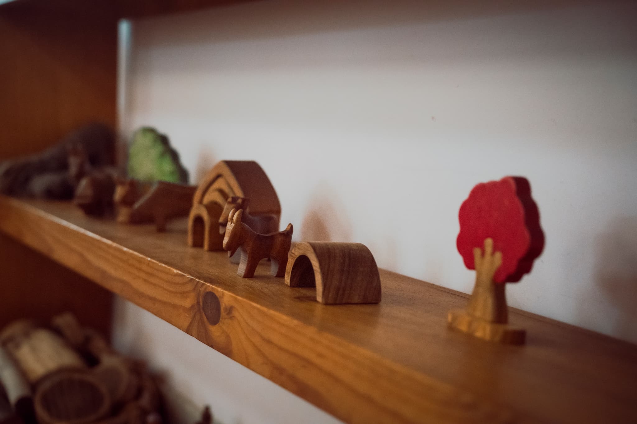 A child playing with wooden trucks in the playgroup